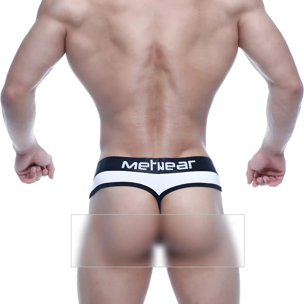 Black and white metro malewear loreto g-string with mefnear branded waistband shown from back side