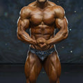 A muscular male bodybuilder wearing blue and white striped metro musclwear basic competition briefs for bodybuilding