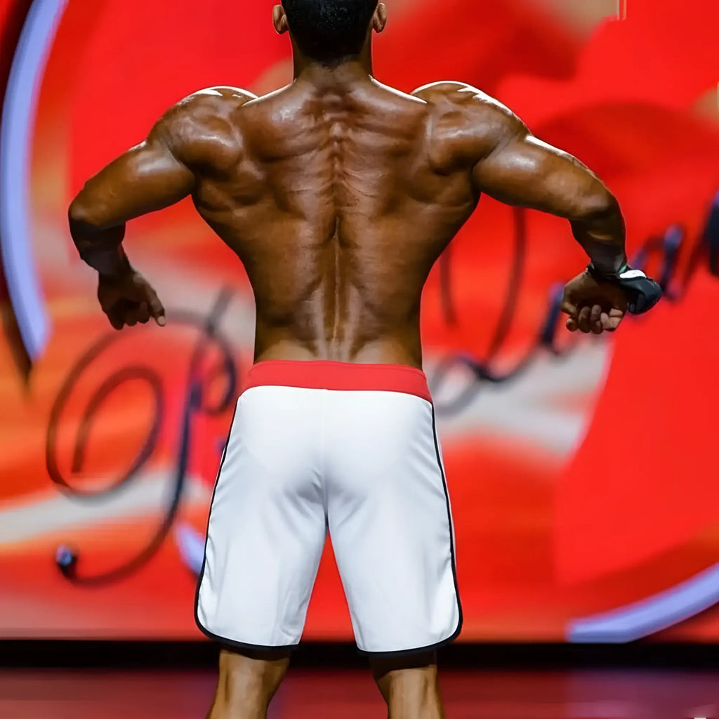 White MetroMaleWear MetroMuscleWear IFBB Pro mens physique board shorts with red waistband and black trim