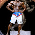 White athletic shorts with blue and red accents drawstring waistband and black bull logo metro malewear ifbb pro board short