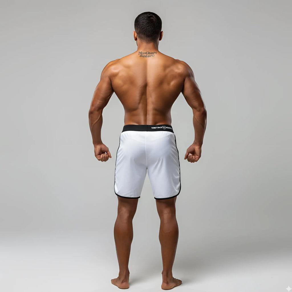 White athletic board shorts with black trim and MetroMaleWear branded waistband for MetroMuscleWear Mark Physique