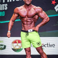 Bright neon green athletic shorts with black waistband and drawstring featuring small shield logo on left leg
