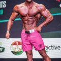 Metro male wear physique board short pink with black drawstring waistband and shield logo on lower right leg