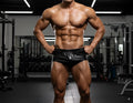 Black shiny leather gym shorts metroMalewear posingwear classic bodybuilding trunk 6 inches front view