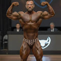 A muscular man flexing in brown and beige zebra-striped briefs from metromalewear posingwear gold zebra posing suit