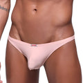 Pink men’s pouch thong from metromalewear featuring a dusty pink color and a small red and white brand tag at the waistband