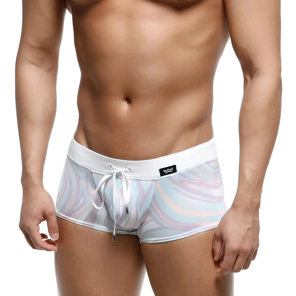 White swim trunks with pastel lavender light blue and pink swirl pattern metroMalewear profundo swim boxer briefs