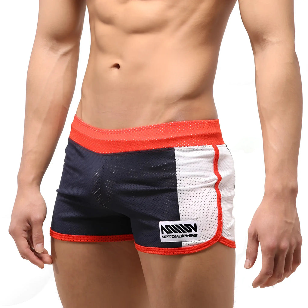 Navy and white mesh athletic shorts with red trim and metro male wear branded patch on the side
