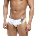White swim trunks with vibrant rainbow stripe and red metro malewear brand tag for beachwear use