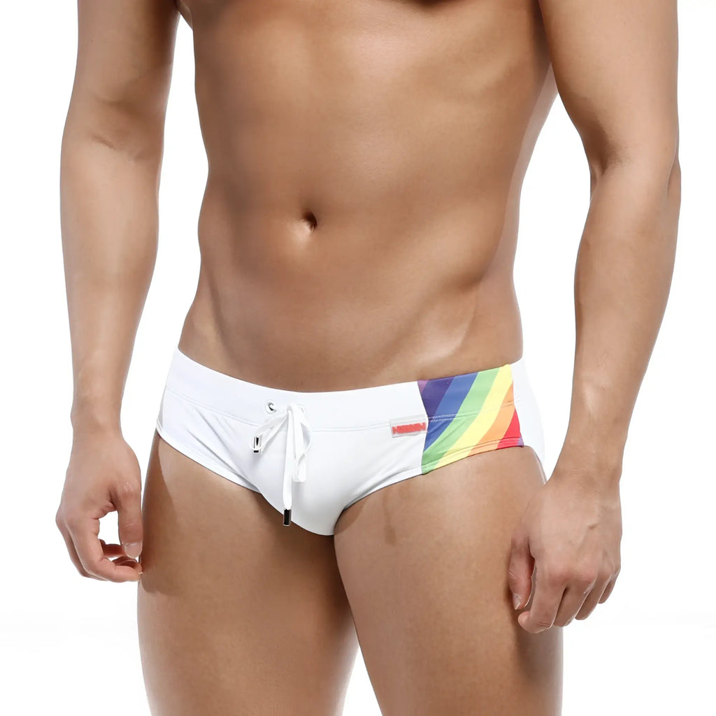 White swim trunks with vibrant rainbow stripe and red metro malewear brand tag for beachwear use