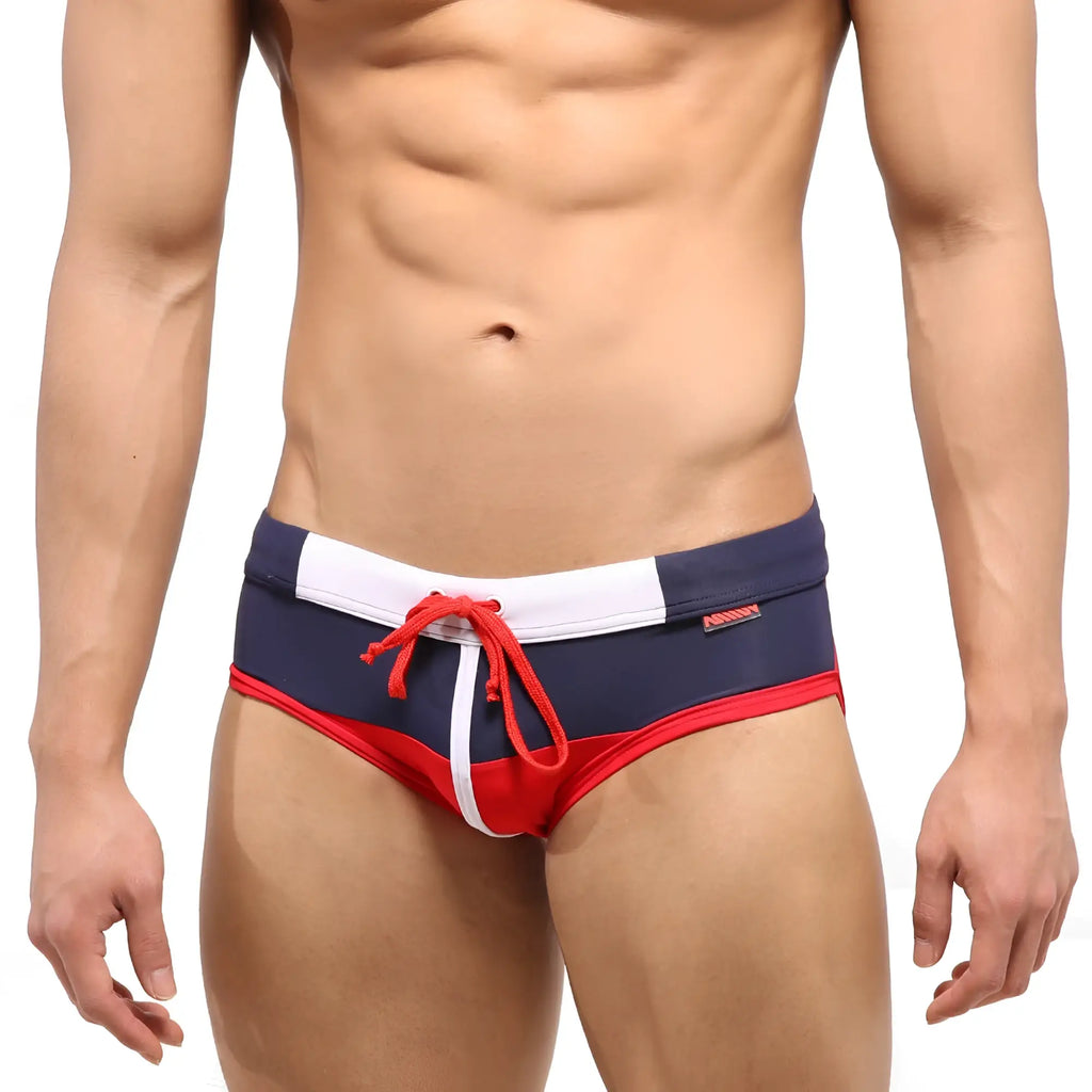 Navy blue and red metro malewear reno swim brief with white trim and red drawstring for swimming and beachwear