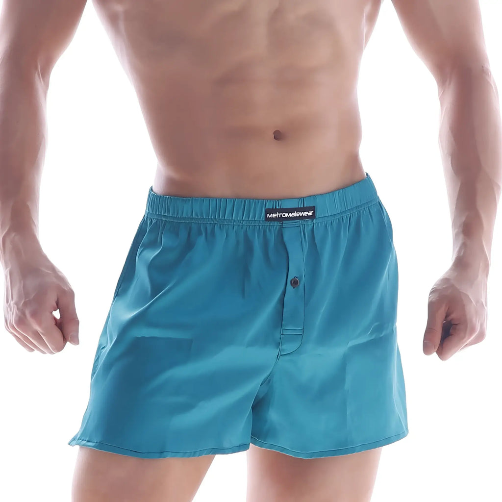 Teal silk satin boxer shorts with elastic waist button closure and metromalewear brand label on waistband