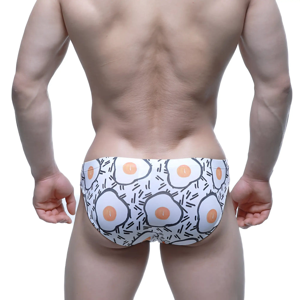 MetroMaleWear sunny side bikini white swim trunks with playful cartoon fried egg pattern and black outline accents