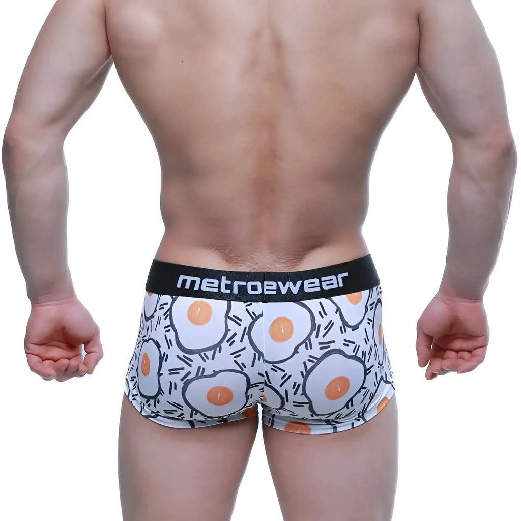 White boxer briefs with playful fried egg pattern and black waistband branded metroewear.