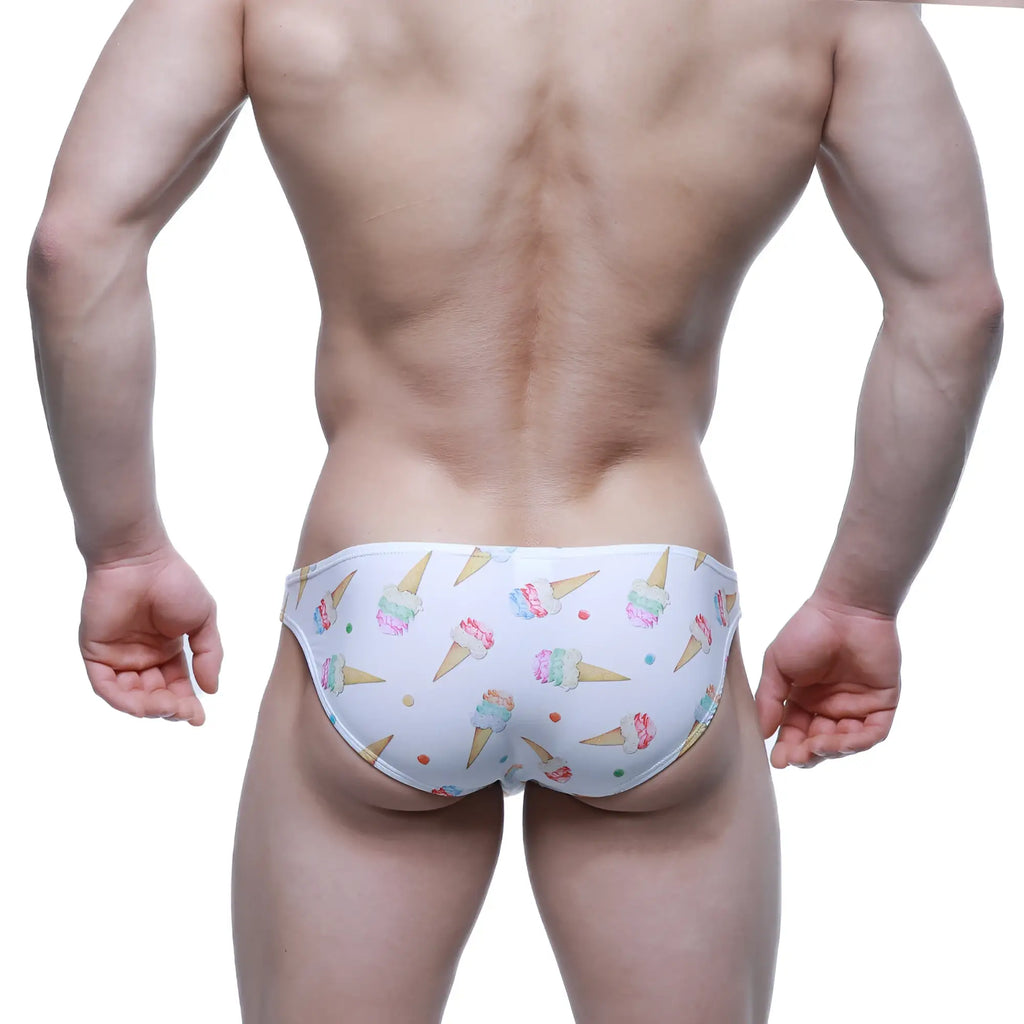 White swim trunks by metromalewear featuring a colorful ice cream cone pattern and playful sprinkles design