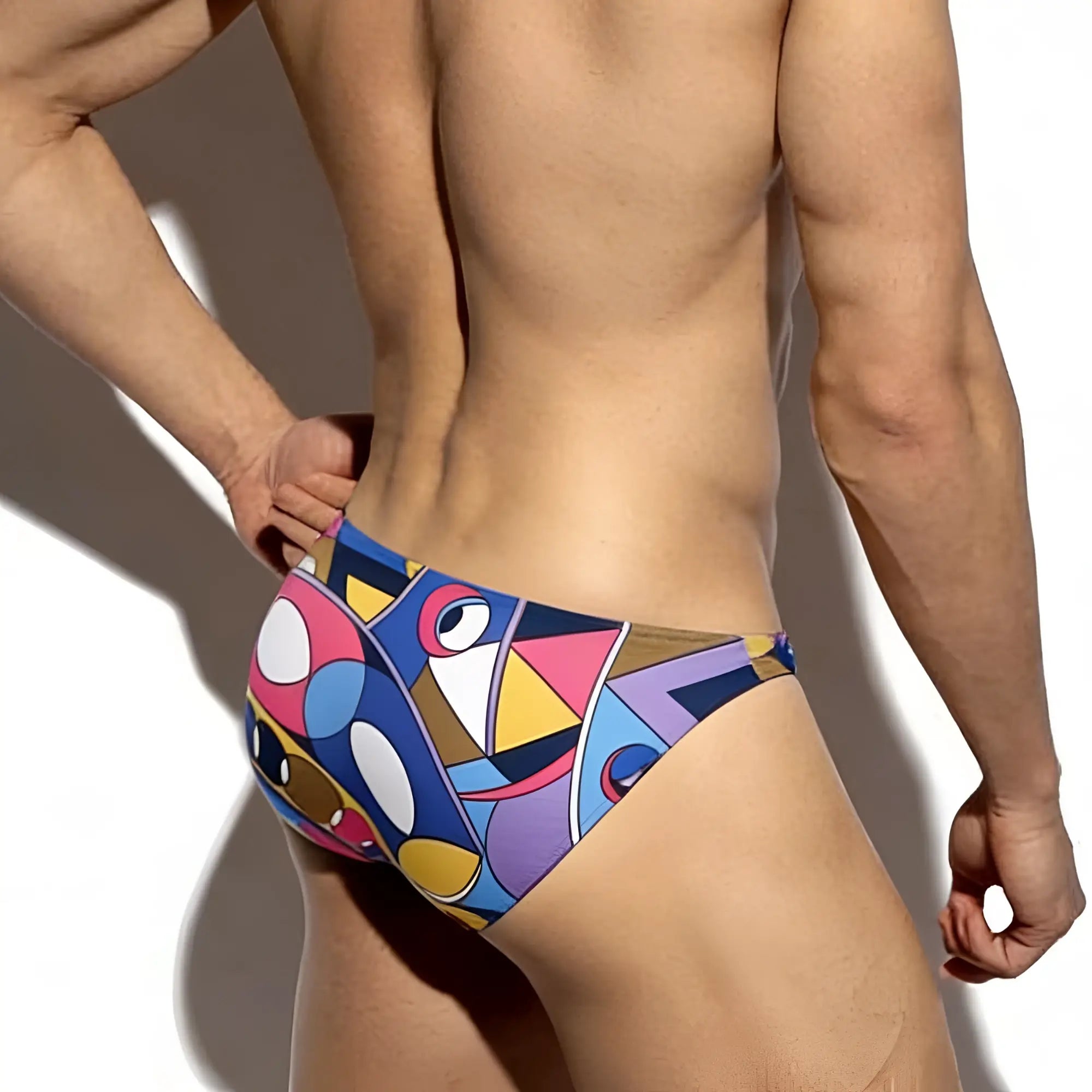 Vibrant geometric patterned swim trunks in bold blues pinks yellows and purples by MetroMaleWear super lowrise bikini Picasso 6116-81