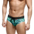 Green tropical leaf-patterned swim trunks with black elastic waistband and drawstring by MetroMaleWear