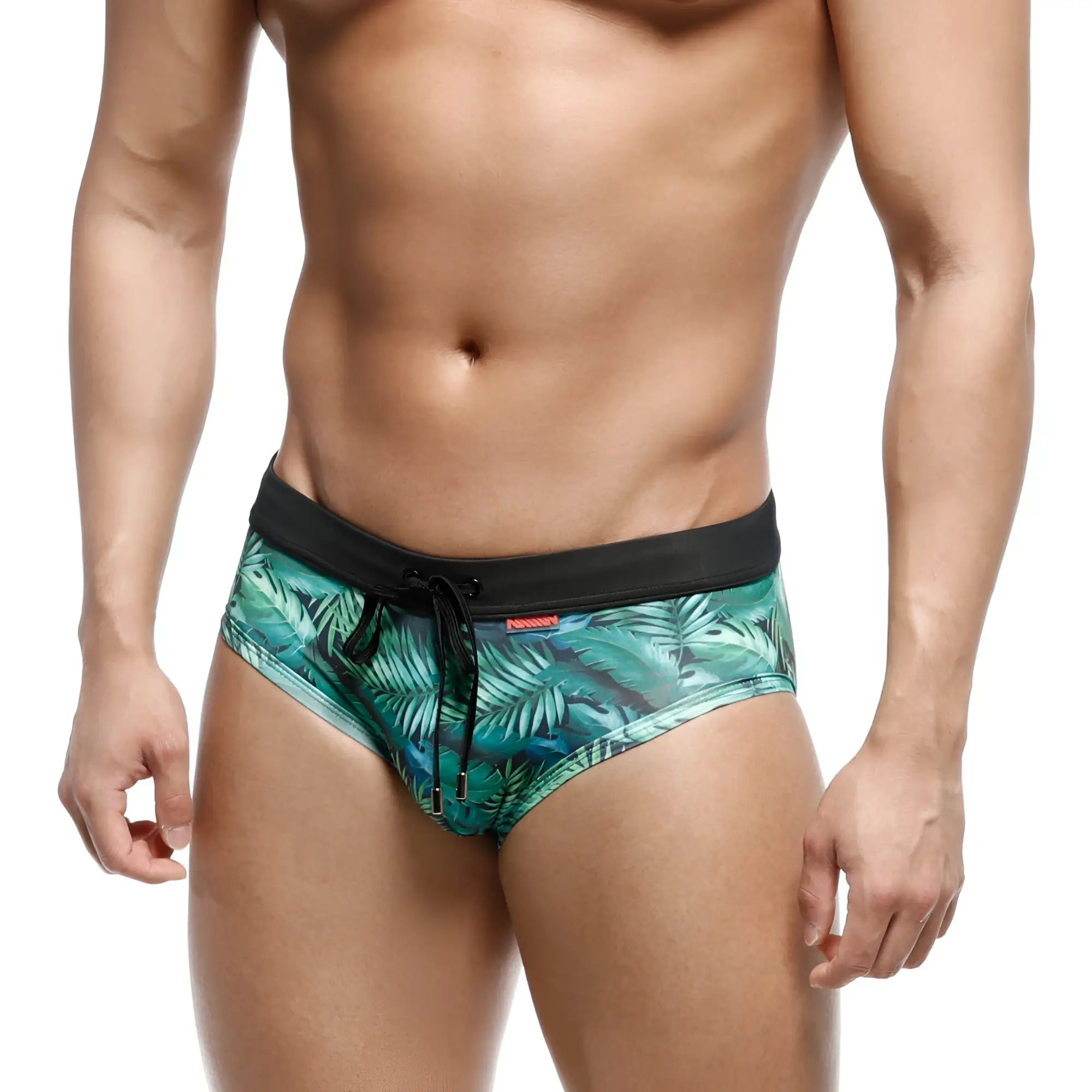 Green tropical leaf-patterned swim trunks with black elastic waistband and drawstring by MetroMaleWear
