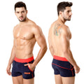 Navy blue terry sport shorts by MetroMaleWear with red elastic waistband side trim and small orange logo on lower left leg
