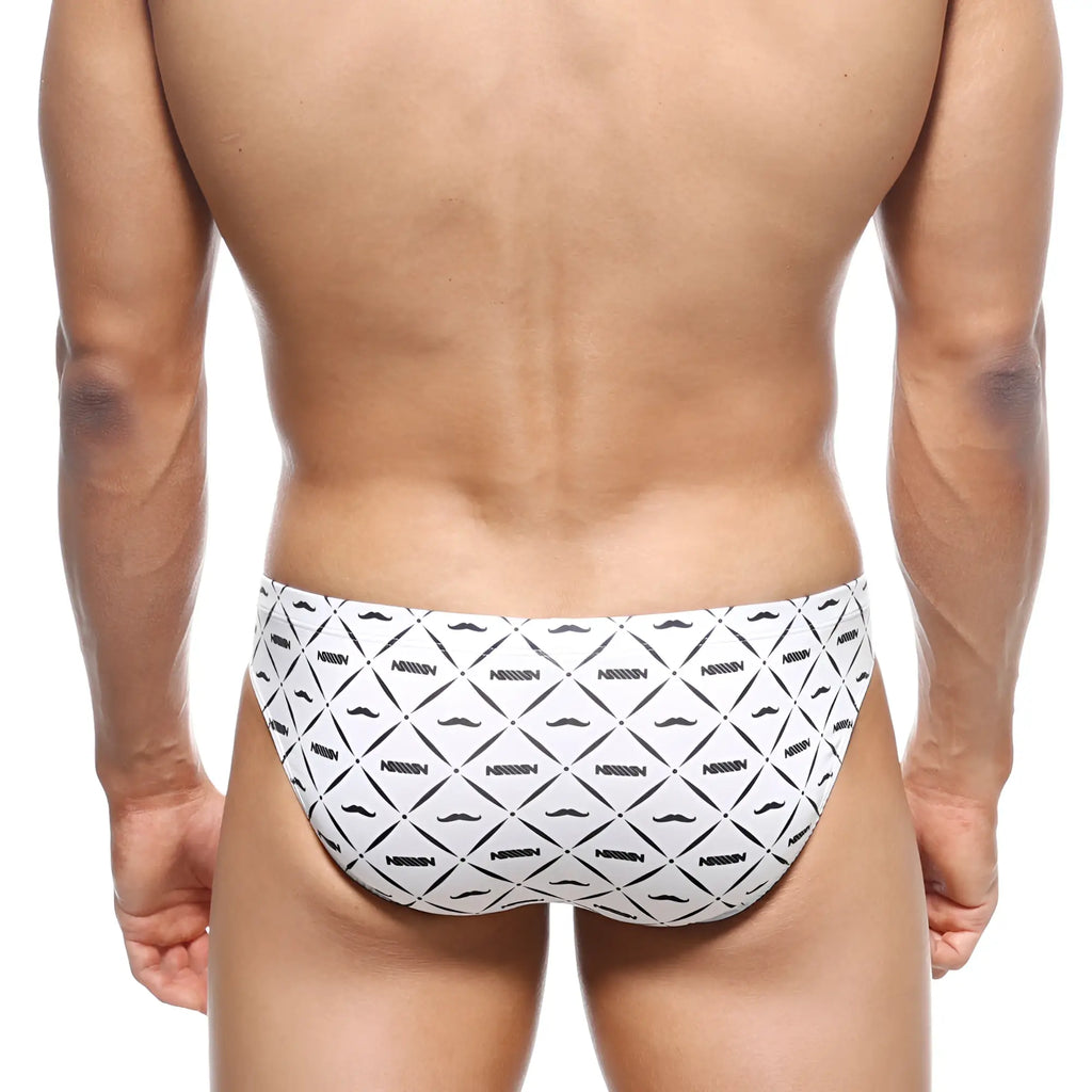 White MetroMaleWear Vasco Hip Brief caballero swim trunks with black geometric mustache pattern and nassim text