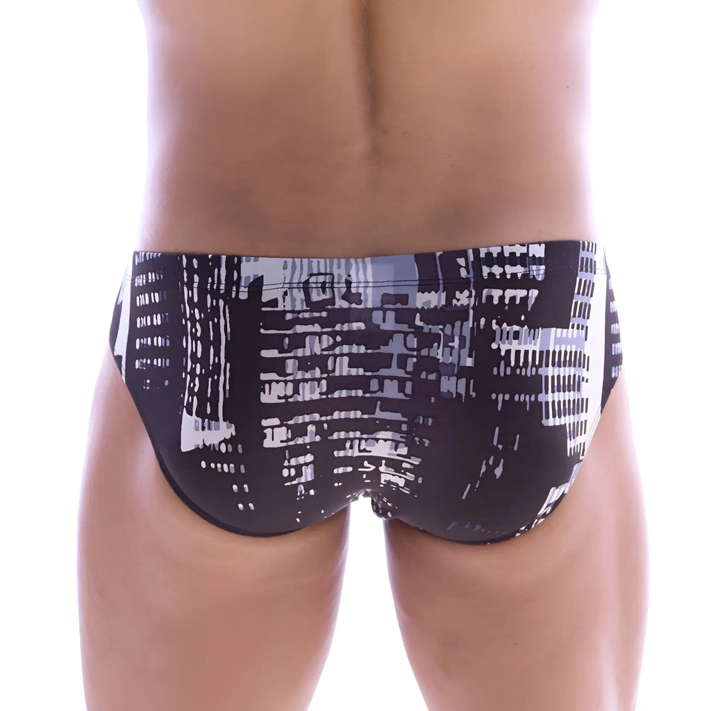 Black swim trunks by metromalewear featuring a bold white and gray stylized cityscape print from the front