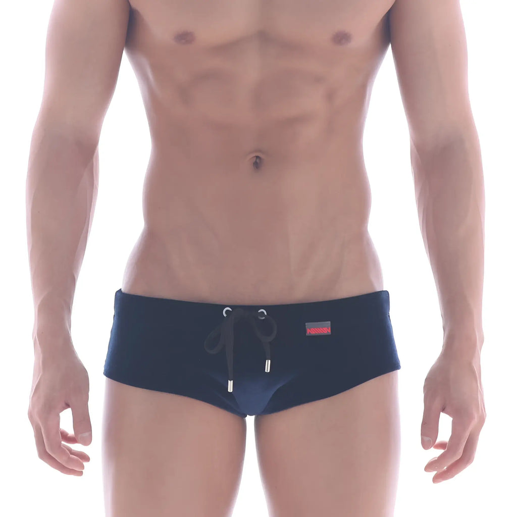 Navy blue velvet swim brief by MetroMaleWear with black drawstring silver metal aglets and red brand tag on waistband