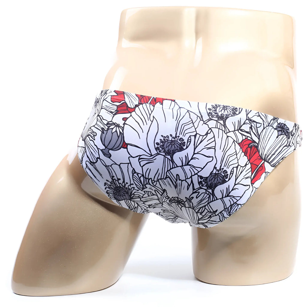White swim trunks by MetroMaleWear Vendeta Bikini Blossom 2614-09 with bold floral pattern black outlines red accents