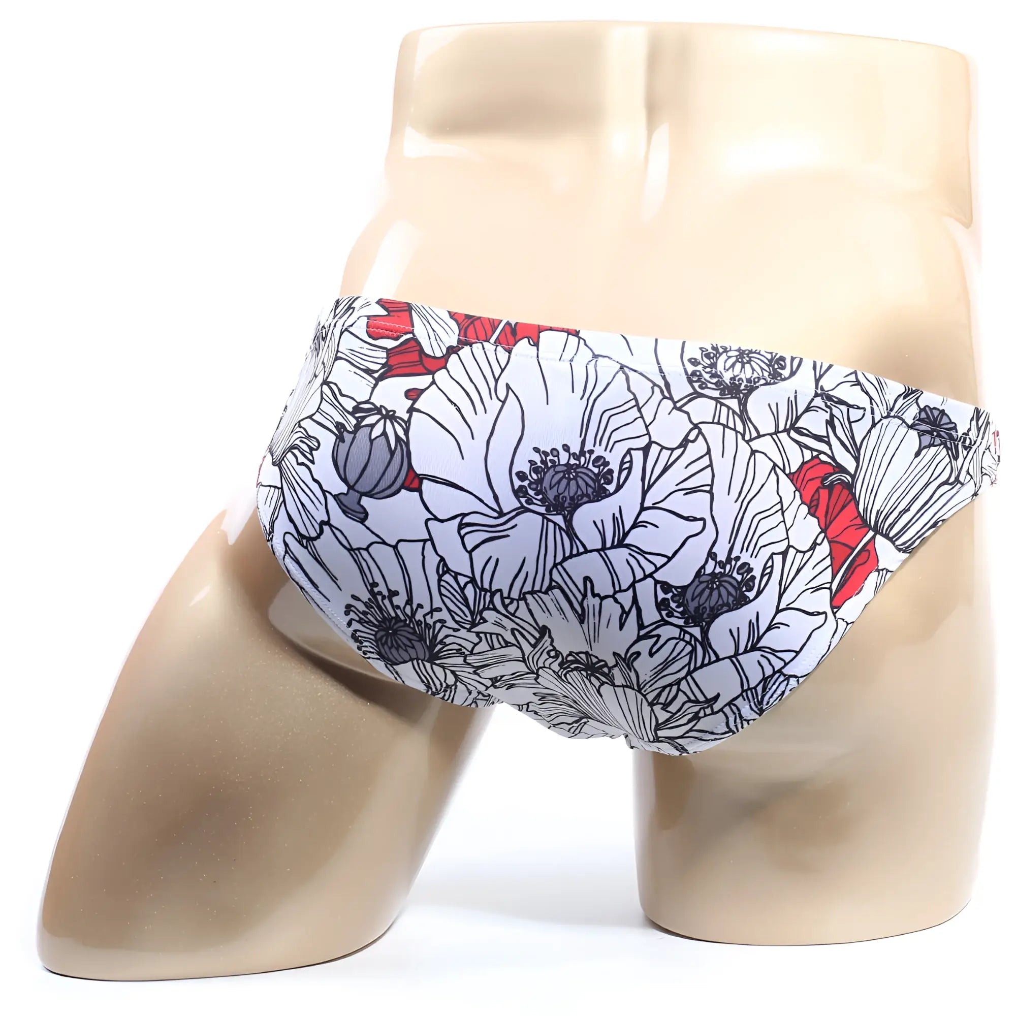 White swim trunks by MetroMaleWear Vendeta Bikini Blossom 2614-09 with bold floral pattern black outlines red accents