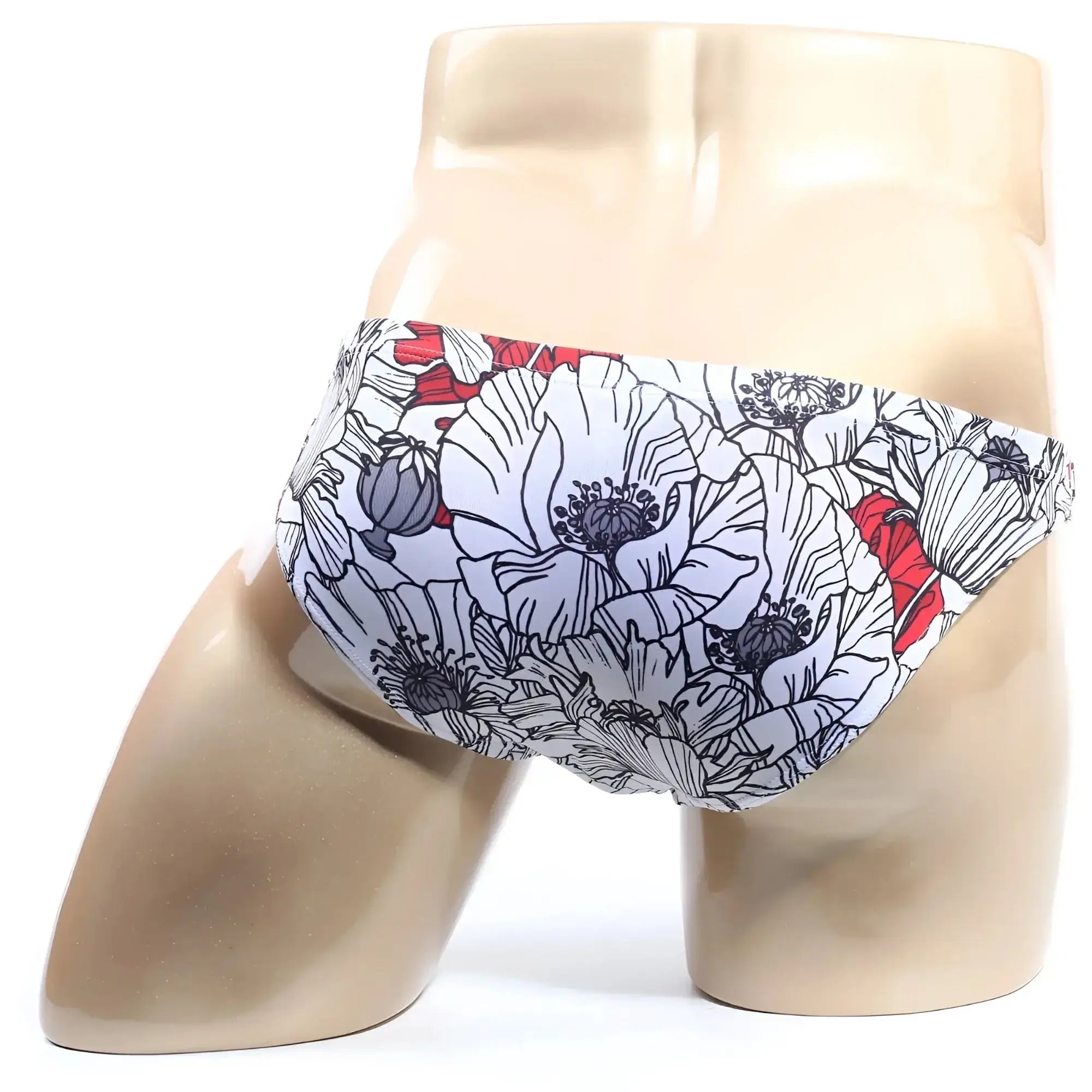 White swim trunks by MetroMaleWear Vendeta Bikini Blossom 2614-09 with bold floral pattern black outlines red accents