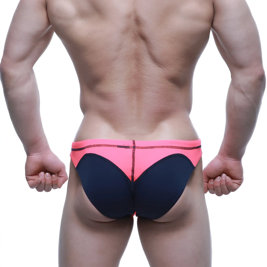 Bright pink and navy blue neon swim bikini by metromalewear with bold color-block design for swimwear use