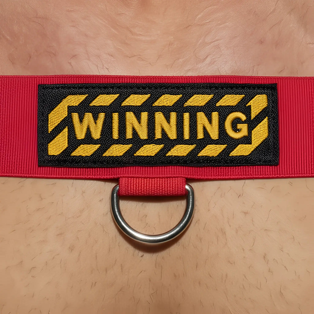 Red woven strap body harness with black and yellow winning patch and silver metal d-ring by MetroMaleWear