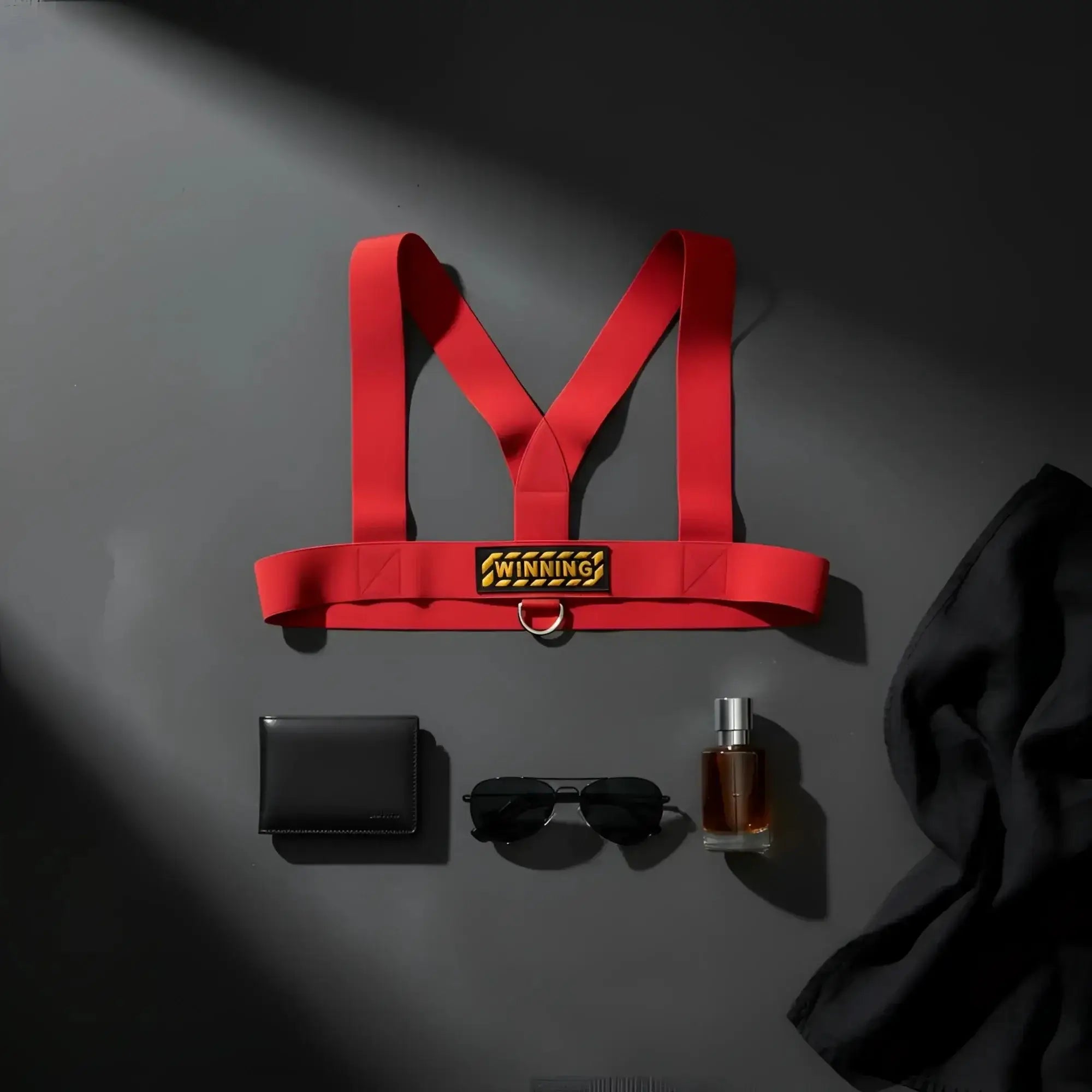 Red elastic metro malewear body harness with gold winning plaque and metal ring for secure fit and style