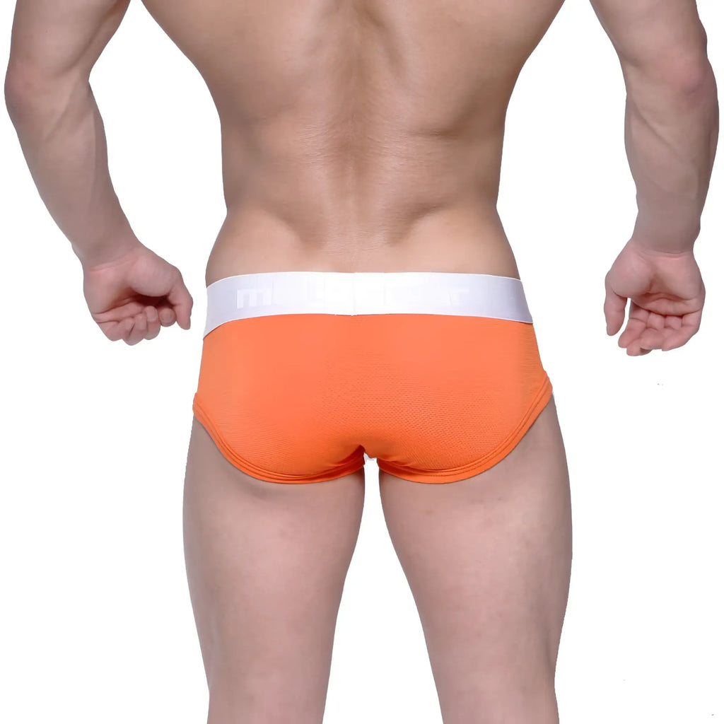 Bright orange MetroMaleWear Max Contour brief with white waistband, textured fabric, and subtle branding on the band