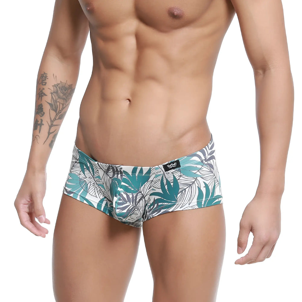 White briefs with vibrant teal and gray tropical leaf pattern and black metro male wear logo on waistband