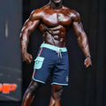 Navy blue MetroMaleWear MetroMuscleWear Marine physique board shorts with light teal trim, side pocket, and drawstring waistband