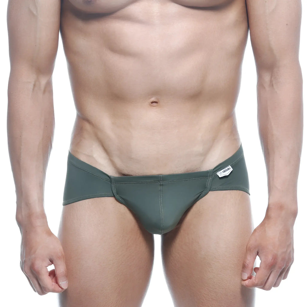 Dark green metro malewear mojito bikini swim trunks with sleek modern design and small white brand tag on waistband