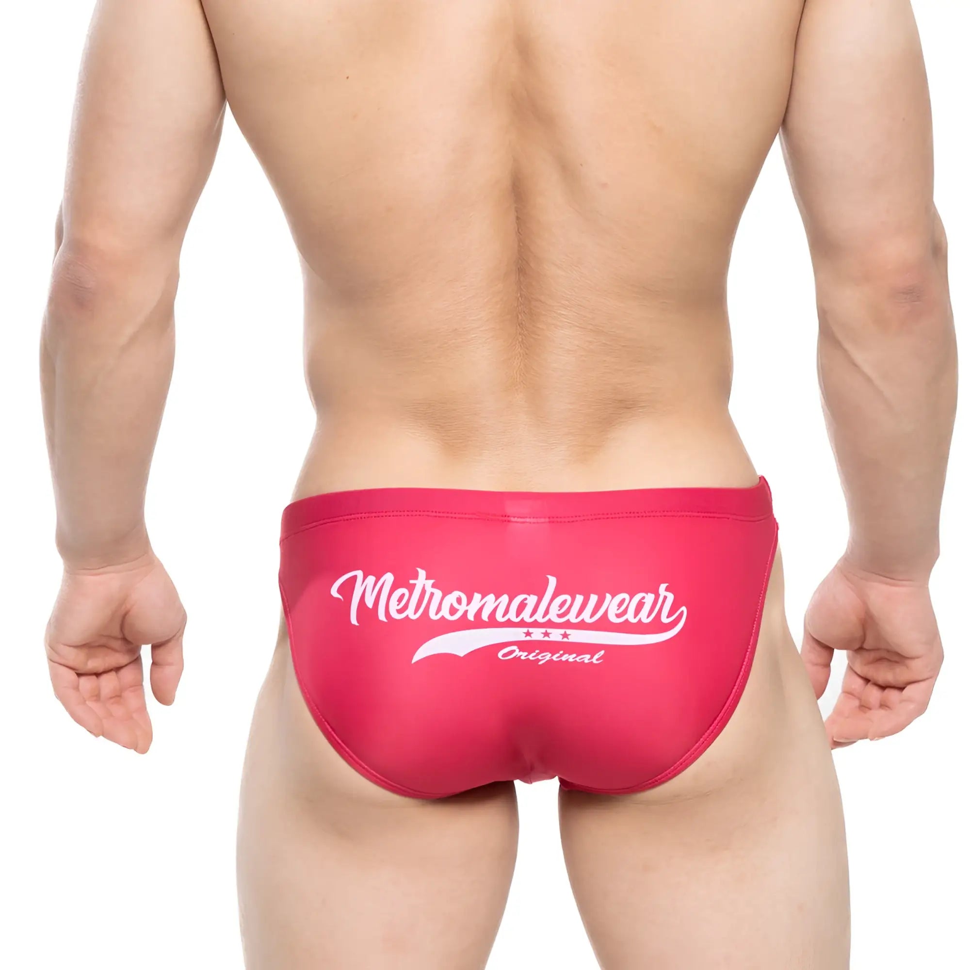 Bright pink mens swim bikini trunks with white metromalewear original logo and three stars for surf use