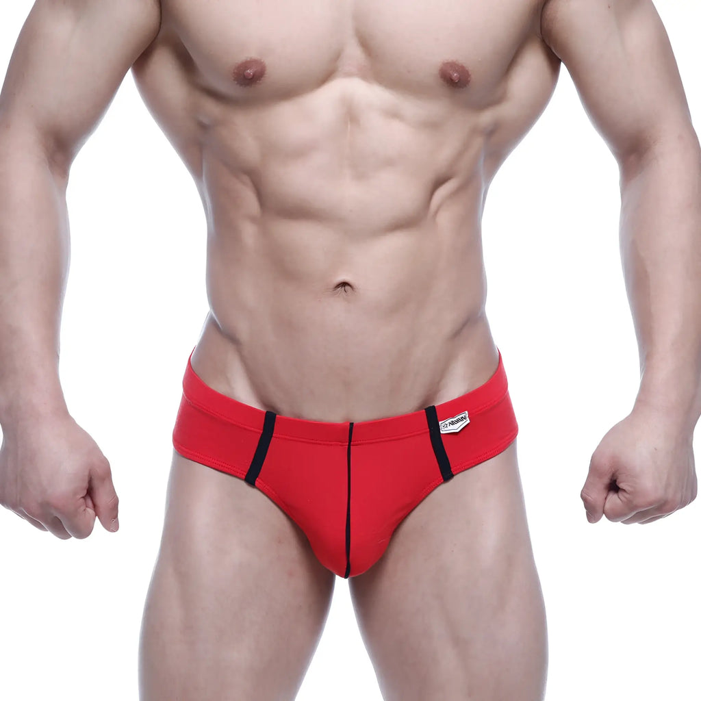 Red athletic briefs with black side stripes and a white metro male wear brand tag on the waistband