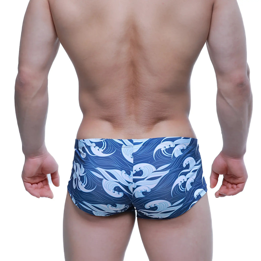 Blue swim trunks by metromalewear featuring a dynamic white and light blue wave pattern for stylish beachwear