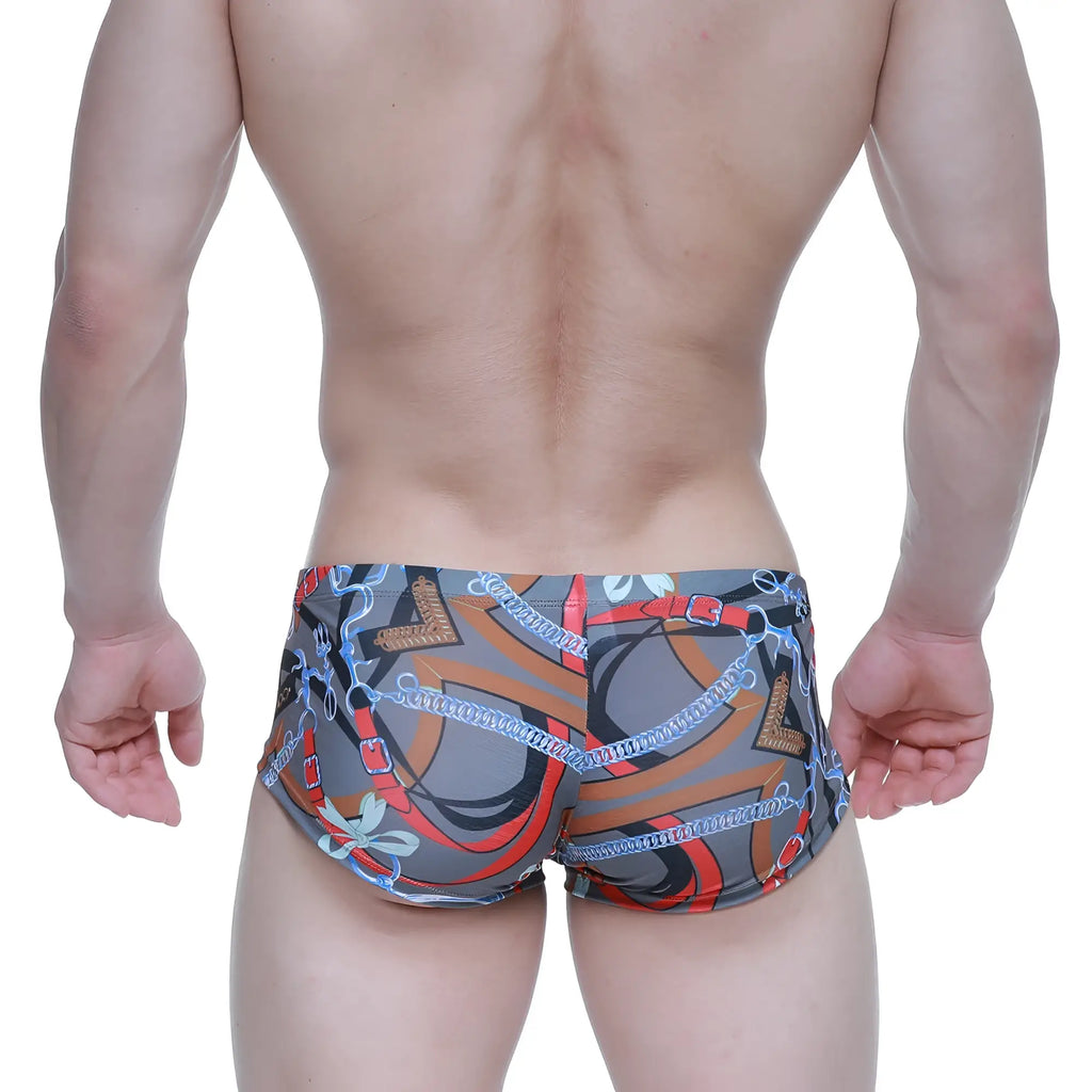 Gray MetroMaleWear Padu Trunk swim trunks with bold orange red and blue chain pattern and metallic accents