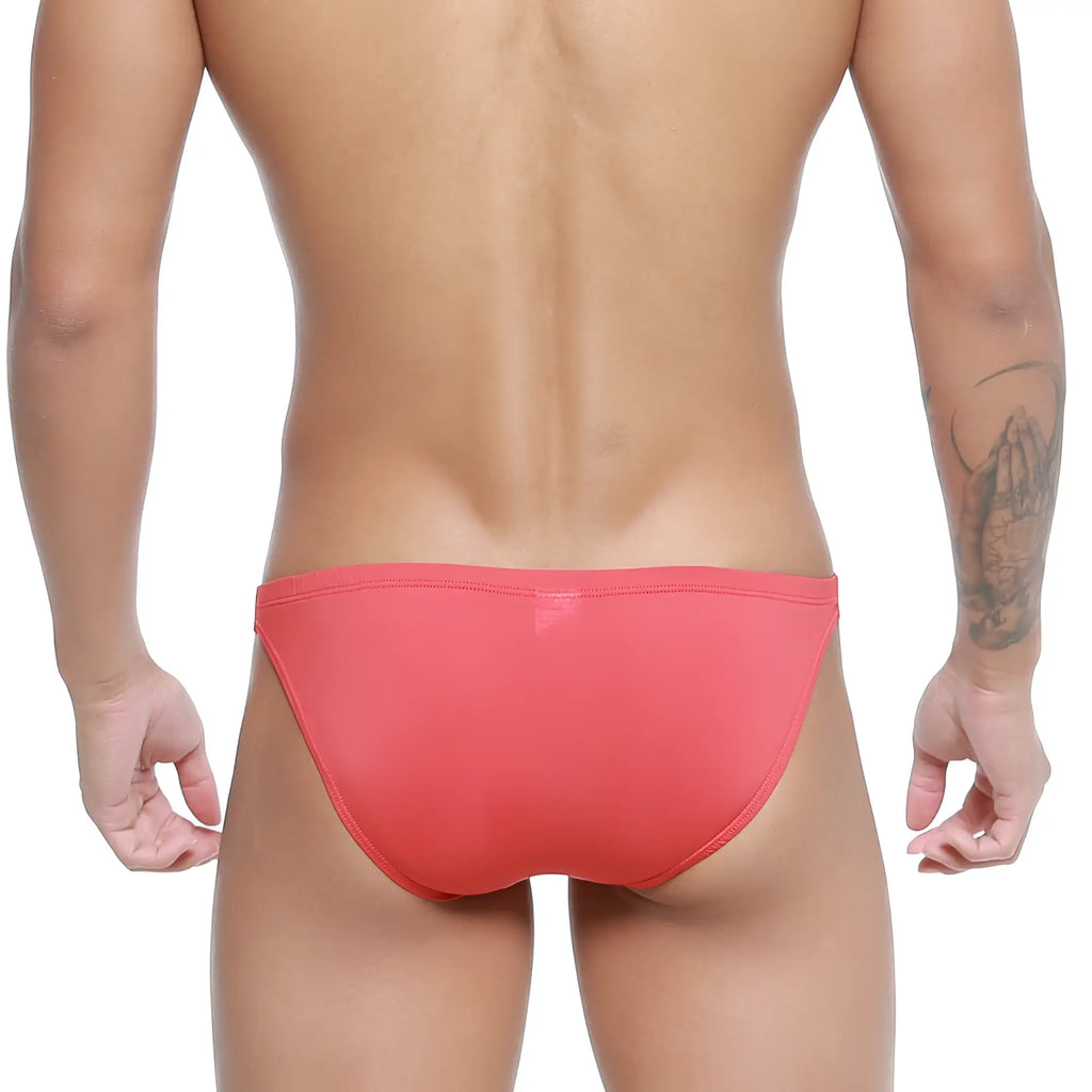 A sleek coral-red metro malewear paleta bikini swim trunk with a smooth form-fitting design for swimming