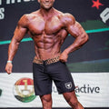 Black MetroMaleWear Physique board shorts with leopard-print waistband and white shield logo on lower left leg