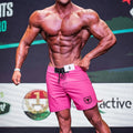Metro male wear physique board short pink with black drawstring waistband and shield logo on lower right leg