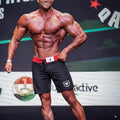 MetroMaleWear physique board short with red waistband black fabric and white logo on left leg for athletic use
