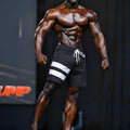 Black MetroMaleWear Physique board shorts with two white stripes drawstring and number 46 for athletic use
