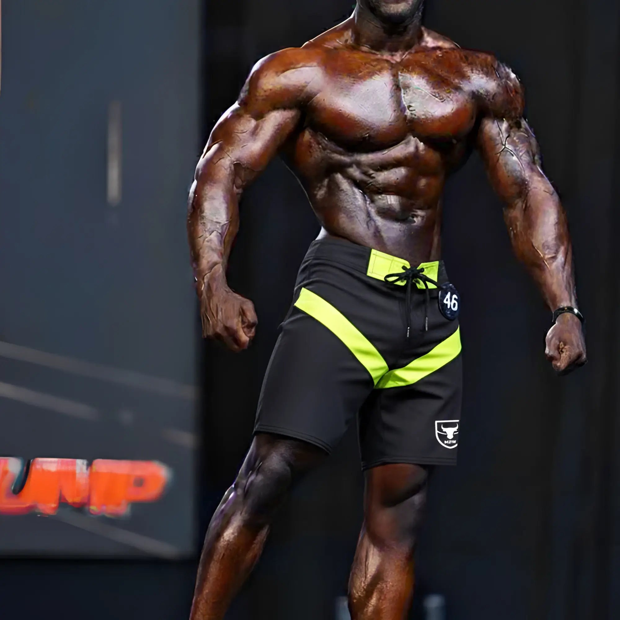 Black and neon yellow MetroMaleWear physique board short victory 4706-46 with drawstring waistband and white logo on left leg