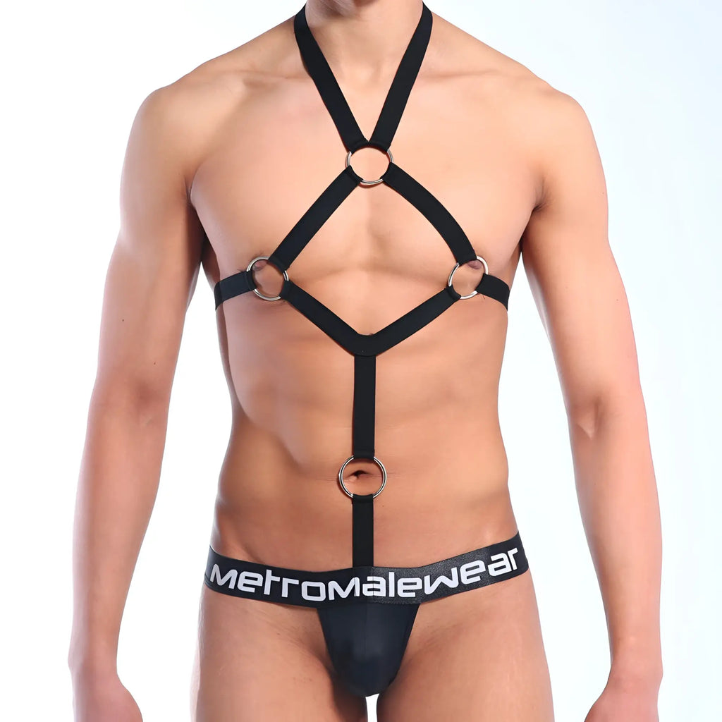 Black harness-style bodysuit with silver metal rings and adjustable straps featuring MetroMaleWear branded waistband