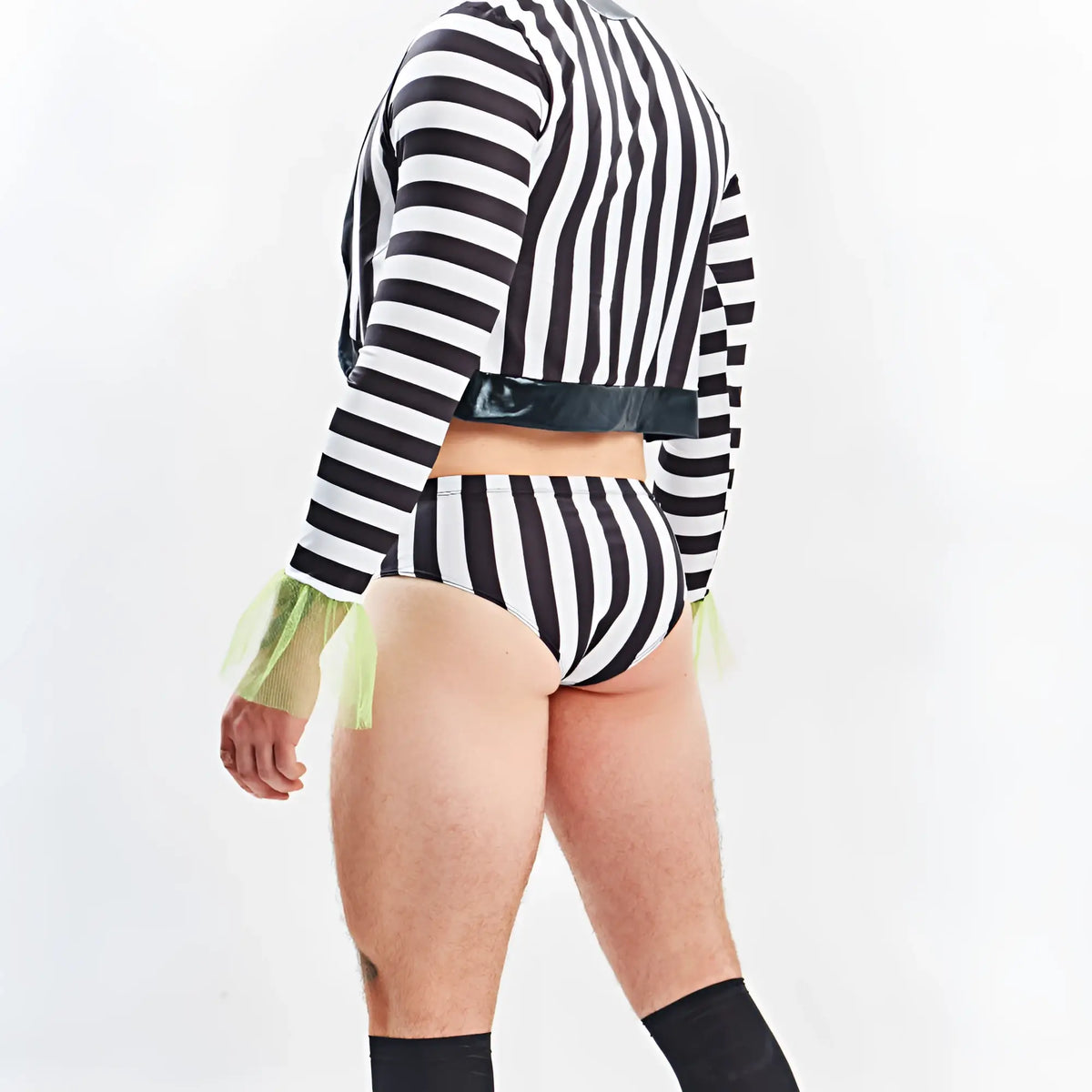 Black and white vertically striped long-sleeved crop top with shiny black belt and neon green mesh cuffs