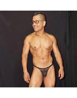 Black tulle micro bikini underwear by Arroyman featuring a sheer design and minimal coverage modeled on a man.