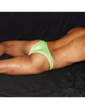Fluorescent green micro bikini posing suit by Arroyman featuring a minimal cut and shiny material shown on a model.